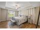 Spacious main bedroom features a tray ceiling, neutral walls, and a window with backyard views at 824 Stanly House St, Wake Forest, NC 27587