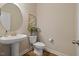 Cozy half-bath features a pedestal sink, neutral walls, and modern fixtures at 824 Stanly House St, Wake Forest, NC 27587