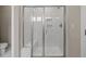 Elegant walk-in shower features floor-to-ceiling marble tile, a bench, and glass doors at 824 Stanly House St, Wake Forest, NC 27587