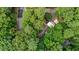 Aerial shot showcases wooded property with mature trees surrounding the roof of the home at 908 Cedar Fork Trl, Chapel Hill, NC 27514