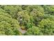 Aerial view showing the property surrounded by dense green trees, offering privacy and natural beauty at 908 Cedar Fork Trl, Chapel Hill, NC 27514