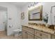 Elegant bathroom with a granite vanity, framed mirror, and neutral color scheme at 908 Cedar Fork Trl, Chapel Hill, NC 27514