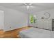 Serene bedroom with hardwood floors, white walls, and a window with nature views at 908 Cedar Fork Trl, Chapel Hill, NC 27514