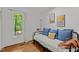 Relaxing bedroom with daybed, bright natural light and hardwood floors at 908 Cedar Fork Trl, Chapel Hill, NC 27514