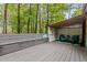 Outdoor deck features a built-in bench and comfortable seating area with chairs, rug, and side table at 908 Cedar Fork Trl, Chapel Hill, NC 27514