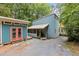 Exterior view of a unique blue home with a detached accessory building at 908 Cedar Fork Trl, Chapel Hill, NC 27514
