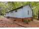 View of the house exterior, showcasing the siding and surrounding natural landscape at 908 Cedar Fork Trl, Chapel Hill, NC 27514