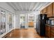 Hallway featuring hardwood floors, French doors, and access to a bathroom and kitchen area at 908 Cedar Fork Trl, Chapel Hill, NC 27514