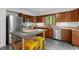 Kitchen area showcasing wood cabinets and stainless steel appliances at 908 Cedar Fork Trl, Chapel Hill, NC 27514
