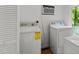 Well-lit laundry room featuring white washer and dryer appliances at 908 Cedar Fork Trl, Chapel Hill, NC 27514