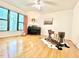 Spacious living room with hardwood floors, large windows, and a music area at 908 Cedar Fork Trl, Chapel Hill, NC 27514