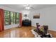 Well-lit music room with hardwood floors, a piano, and drums with a view of the outdoors at 908 Cedar Fork Trl, Chapel Hill, NC 27514