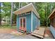 Exterior of the outbuilding featuring a side deck and double doors at 908 Cedar Fork Trl, Chapel Hill, NC 27514