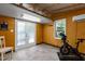 Versatile workout space with an exercise bike, AC, and bright lighting, suitable for a home gym at 908 Cedar Fork Trl, Chapel Hill, NC 27514