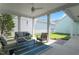 Cozy, covered back porch with outdoor seating, ceiling fan, string lights and neutral color scheme, perfect for relaxing at 979 Branch Line Ln, Apex, NC 27502