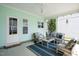 Comfortable, covered back porch with stylish seating and decor, offering a tranquil outdoor living space at 979 Branch Line Ln, Apex, NC 27502