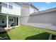 Backyard and exterior view featuring lush lawn and adjacent covered porch with outdoor seating, perfect for entertaining at 979 Branch Line Ln, Apex, NC 27502