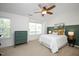 Bedroom features a ceiling fan, natural light, neutral carpet, and unique decor at 979 Branch Line Ln, Apex, NC 27502