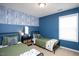 Blue bedroom with two beds, a modern accent wall, and natural light at 979 Branch Line Ln, Apex, NC 27502