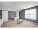Spacious bedroom offering neutral carpet, gray walls, and bright windows, with space for a table and chairs at 979 Branch Line Ln, Apex, NC 27502