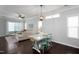 Bright dining area with hardwood floors, stylish light fixture, and convenient access to a modern kitchen at 979 Branch Line Ln, Apex, NC 27502