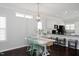 Bright dining area with hardwood floors, stylish light fixture, and convenient access to a modern kitchen at 979 Branch Line Ln, Apex, NC 27502