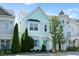Charming two-story home with light blue siding, well-maintained landscaping, and mature trees on a sunny day at 979 Branch Line Ln, Apex, NC 27502
