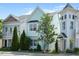 Charming two-story home with light blue siding, well-maintained landscaping, and mature trees on a sunny day at 979 Branch Line Ln, Apex, NC 27502