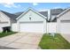 Attached garage with a white door and light blue siding at 979 Branch Line Ln, Apex, NC 27502