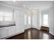 Open kitchen area with white cabinets, stainless steel appliances, and dark hardwood floors at 979 Branch Line Ln, Apex, NC 27502