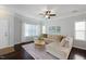 Bright living room features hardwood floors, a comfortable sectional sofa, and an open concept design at 979 Branch Line Ln, Apex, NC 27502