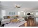 Bright living room features hardwood floors, a comfortable sectional sofa, and an open concept design at 979 Branch Line Ln, Apex, NC 27502