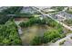Aerial view of the community pond surrounded by lush green trees and landscaping at 979 Branch Line Ln, Apex, NC 27502