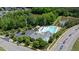 Aerial view of a community pool with lush greenery, water features, and parking at 979 Branch Line Ln, Apex, NC 27502