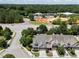 Aerial view of townhomes near a wooded area, displaying the community's layout and surrounding environment at 103 Aisling Ct, Cary, NC 27513