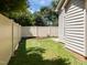 Fenced backyard with green grass and colorful flowerbed at 103 Aisling Ct, Cary, NC 27513