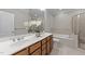 Bathroom featuring double sinks, an undermount tub, and tiled shower at 103 Aisling Ct, Cary, NC 27513