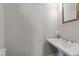 Powder room featuring a pedestal sink and mirror at 103 Aisling Ct, Cary, NC 27513