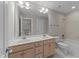 Bathroom with double sink vanity, large mirror, tile flooring, and combined shower and tub at 103 Aisling Ct, Cary, NC 27513