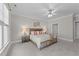 Relaxing bedroom featuring a ceiling fan, crown moulding, and carpeted floors at 103 Aisling Ct, Cary, NC 27513