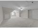 Large bonus room featuring carpet, a ceiling fan, windows, and storage nook at 103 Aisling Ct, Cary, NC 27513