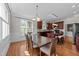 Open-concept dining area adjacent to kitchen with natural light and wooden dining table and chairs at 103 Aisling Ct, Cary, NC 27513