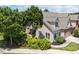 Charming home with beige siding, gray roof, mature trees, and landscaped front yard at 103 Aisling Ct, Cary, NC 27513