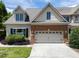 Inviting two-story home featuring a brick facade, manicured landscaping, and an attached two-car garage at 103 Aisling Ct, Cary, NC 27513