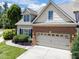 Lovely exterior view of the home showing the well-manicured lawn, garage and overall curb appeal at 103 Aisling Ct, Cary, NC 27513
