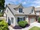 Exterior home view featuring light siding, a two-car garage, and manicured landscaping at 103 Aisling Ct, Cary, NC 27513