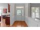 Bright foyer with hardwood flooring, decorative molding, and a glass-paneled front door at 103 Aisling Ct, Cary, NC 27513