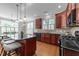 Spacious kitchen with a large island, dark countertops, ample cabinet storage, and natural lighting at 103 Aisling Ct, Cary, NC 27513