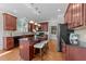 Well-appointed kitchen featuring an island with bar seating, dark countertops, and stainless steel appliances at 103 Aisling Ct, Cary, NC 27513