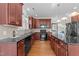 Elegant kitchen featuring dark countertops, stainless steel appliances, and hardwood floors at 103 Aisling Ct, Cary, NC 27513